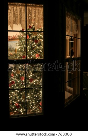 Christmas tree seen through bay window of home