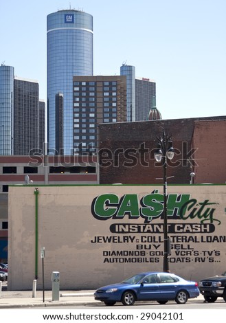 DETROIT - April 11, 2009 - A Pawn shop sign on the side of a building in downtown Detroit with the financaily ailing  General Motors headquarters in background. GM is facing possible bankruptcy.