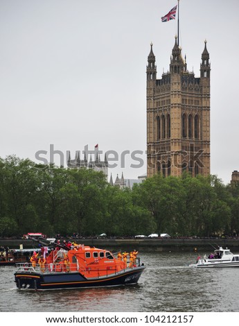 LONDON - JUNE 3rd 2012: RNLI lifeboat outside House of Parliament during Queen Elizabeth Diamond Jubilee River Pageant on June 3rd 2012 in London