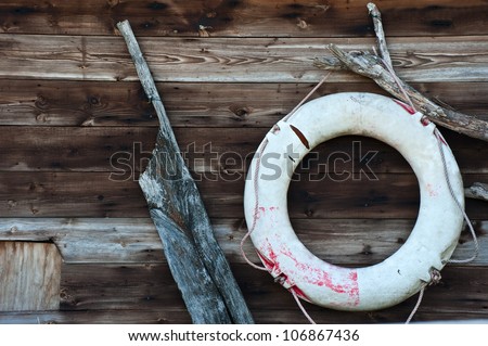 Nautical objects leaning against worn wooden background