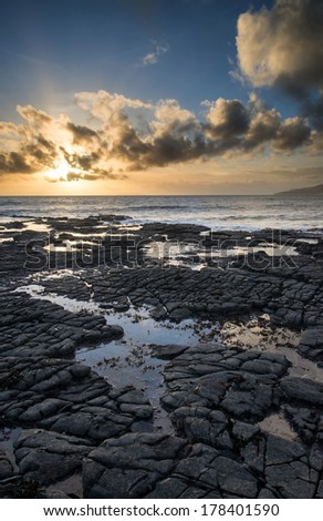 Stunning landscape ocean at sunset dramatic clouds