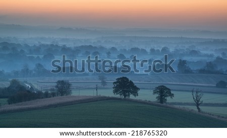 Beautiful countryside foggy sunrise landscape with layers of fog