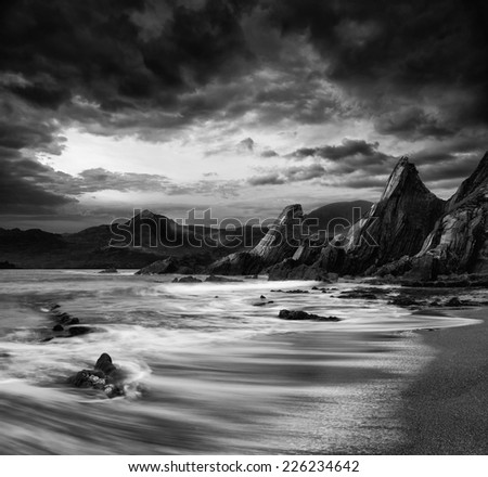 Stunning mountain and sea sunset landscape  black and white