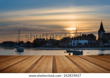 Landscape peaceful harbor at sunset with yachts in low tide with wooden planks floor