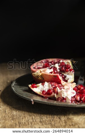 Moody natural lighting images of fresh juicy pomegranate with vintage style