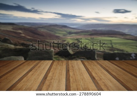Stunning Autumn Fall landscape of Hope Valley from Stanage Edge in Peak District with wooden planks floor