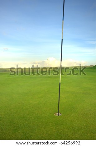 View of golf course with moody sunrise over English landscape