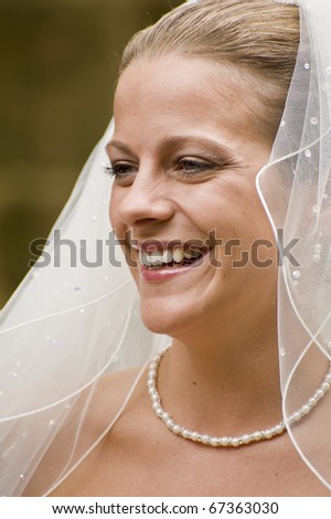 Natural portrait of beautiful young bride smiling