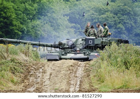 LONDON - JULY 21 - Unidentified members of the public drive modern era tank during War and Peace Show, largest military sohw in the world, on July 21st, 2011 near London, England