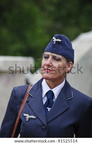 LONDON - JULY 21 - Unidentified member of the public poses as female German officer in WW2 era in largest reenactment of WW2 in the world at War and Peace, 21st July 2011 in London, England