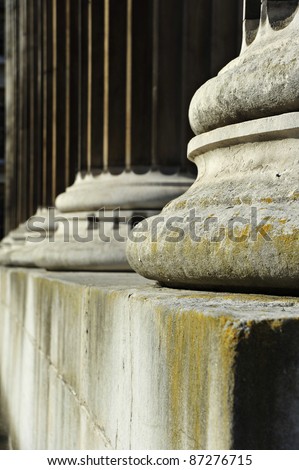 Shallow depth of field on line of stone pillars, concept of strength, justice and integrity