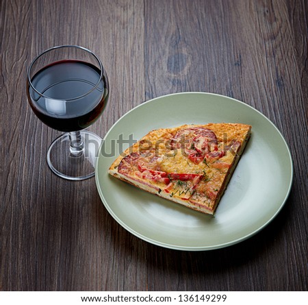 Piece of pizza and glass of wine