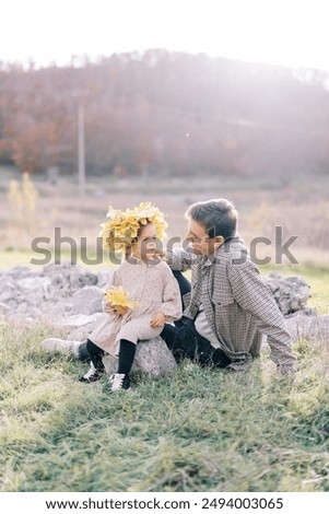 Similar – Image, Stock Photo Two hands put leaves into a fast foaming flowing river.