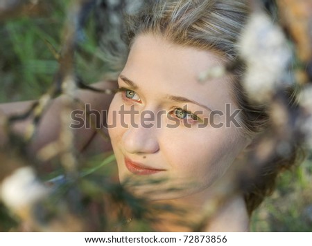 Portrait of natural blond girl with beautiful skin in forest. Close - up.