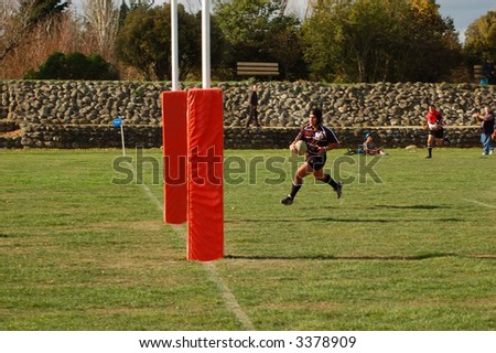 player running to score a try (goal) in rugby