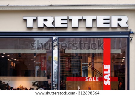 MUNICH, GERMANY - 4 AUGUST 2015: Logo of TRETTER - very popular german shoes store. The chain is trying to attract more costumers, while offering some of its goods at sale prices.