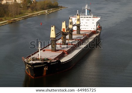 VARNA, BULGARIA - NOVEMBER 11: Cargo ship SERVET-Y (Flag: Turkey) sails  into open sea after being loaded with 30 000 tonnes of triple superphosphate on November 11, 2010 in Varna, Bulgaria.