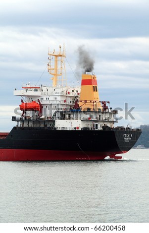 VARNA, BULGARIA - NOVEMBER 27: Cargo ship VOLA 1  (Year Built: 1992, Flag: Malta) sails into open sea after a major revamp work on November 27, 2010. Ship\'s destination is Port of Mariupol, Ukraine.