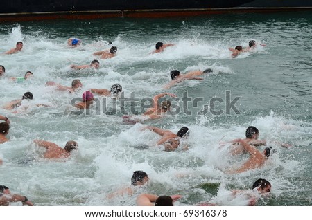 VARNA, BULGARIA - JANUARY 6: A number of young men braved the freezing Black sea waters to \