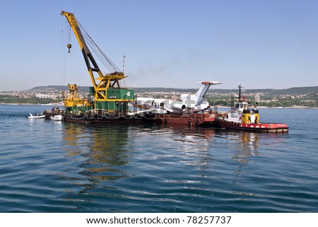 VARNA, BULGARIA - MAY 25: Submerging operation of the former government aircraft on May 25, 2011 in Varna, Bulgaria. The plane is to become large artificial reef, tourist and diving attraction.