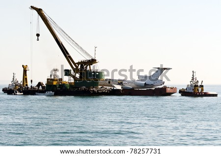 VARNA, BULGARIA - MAY 25: Submerging operation of the former government aircraft on May 25, 2011 in Varna, Bulgaria. The plane is to become large artificial reef, tourist and diving attraction.