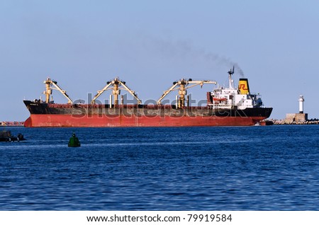 VARNA, BULGARIA - JUNE 21: Cargo ship PATRIOT R (Built: 1981, Flag: St Vincent Grenadines) sails towards Port of Varna-East to load 13200 t of barley on June 21, 2011 in Varna, Bulgaria.