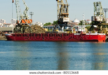 VARNA, BULGARIA - JUNE 24: Cargo ship ST. FILIP (IMO: 7928794, Year Built: 1980, Flag: Comoros) is loaded with 1000 t of scrap metal in Port of Varna-East on June 24, 2011 in Varna, Bulgaria.