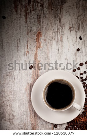 top view on cup of coffee over grunge wooden bacgkround