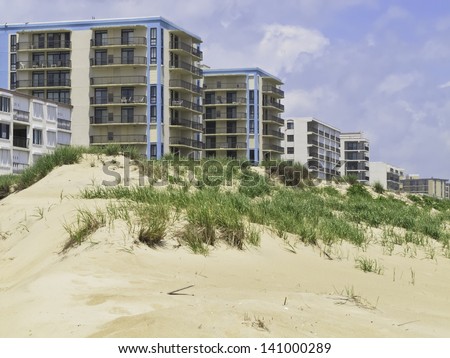 Coastal landscape: Row of high-rises with ocean views by dune along beach in Ocean City, Maryland