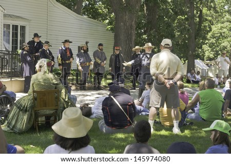 WAUCONDA, ILLINOIS/USA - JULY 13: American Civil War (1861-1865) reenactment on July 13, 2013, in Wauconda, Illinois. General Robert E. Lee describes war strategy to various onlookers before battle.