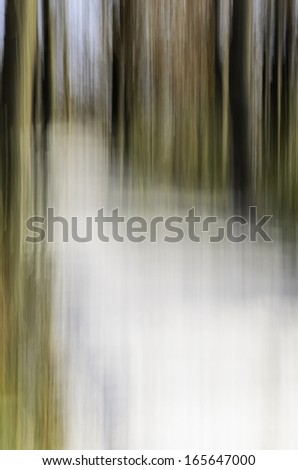 Abstract of snowy path in woods: Painterly motion blur of uphill path covered with snow in November, northern Illinois