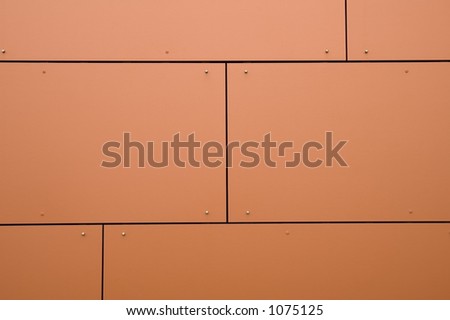 Section of modular orange wall panels on college building
