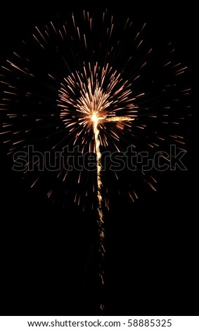 Burst of yellow-white and reddish fireworks inside its own clouds of embers, with rocket trail