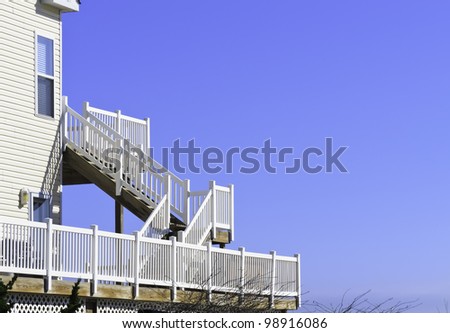 Ocean view, with copy space: White wooden staircase behind beach house overlooking the  Atlantic Ocean