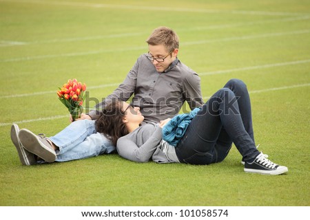 young woman lying on mans lap