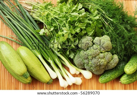 fresh green vegetables on wooden pad
