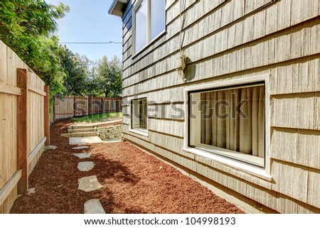 House with fence and space between it.