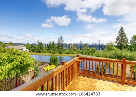 Beautiful wood balcony deck with view of the lake.