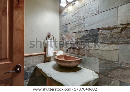 Absolutly stunning bathroom interior deisgn in a luxury rustic cabin style American home with stone and wood, venetian plaster and caling tones. ストックフォト © 