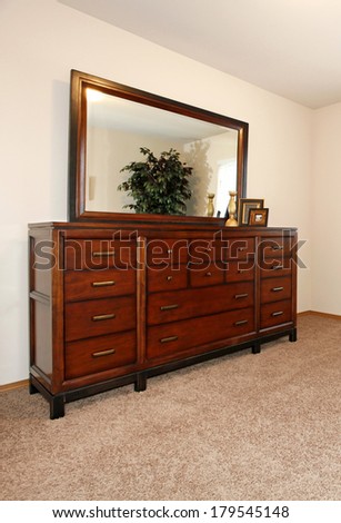 Beautiful cherry dresser with drawers and mirror.