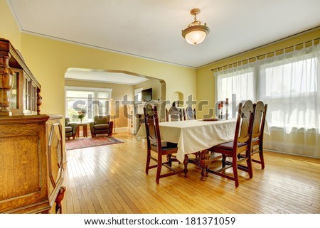 Beautiful elegant dining room with antique carved wood table set and cabinet