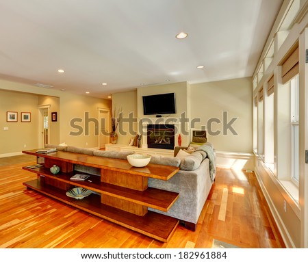 Luxury living room with fireplace and TV. View of couch and three level table set behind it