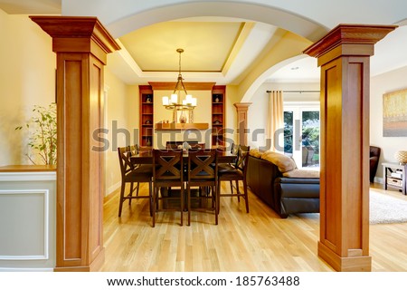 Luxury dining room with column arch. View of classic dining table set