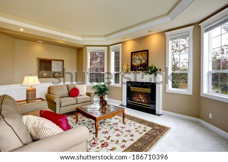 Luxury living room with french windows, fireplace and glass top coffee table