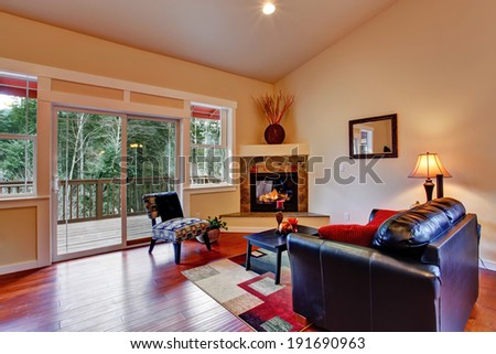 Cozy living room interior with walkout deck and fireplace.