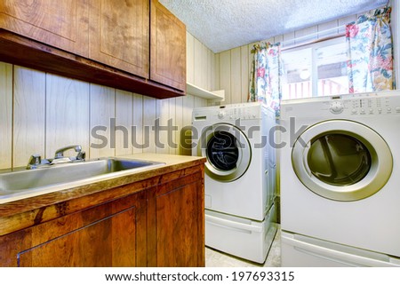 Small laundry room with old cabinets and modern appliances