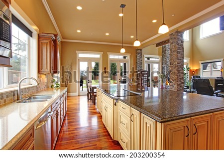 Spacious kitchen interior with kitchen island and dining area in luxury house