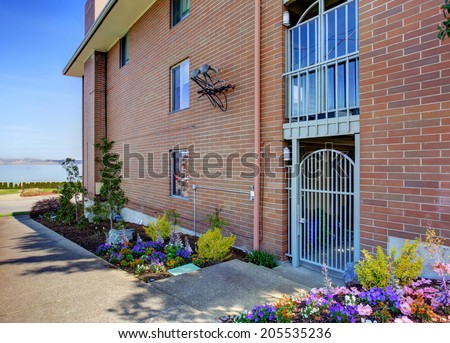 Brick residential building. Entrance gate view from walkway