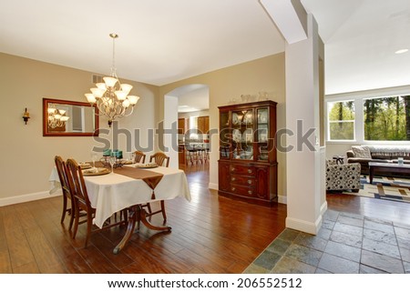 Bright dining area in old house. View of old dining table set and cabinet