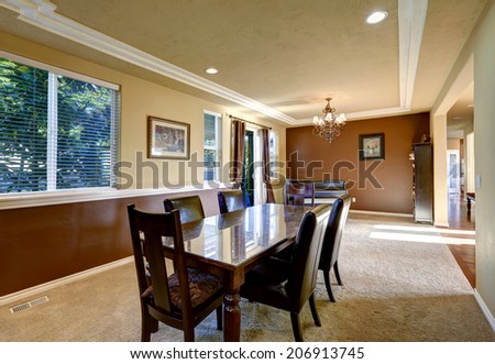 Ivory and brown dining room  with piano and dining table set